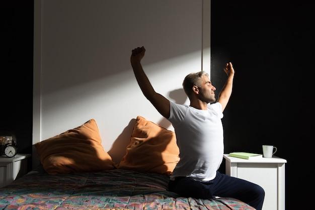 Como Estudar: 6 Segredos para Você Estudar Melhor em 2025 1 Hispanic man stretching out in his bedroom. Morning routine concept